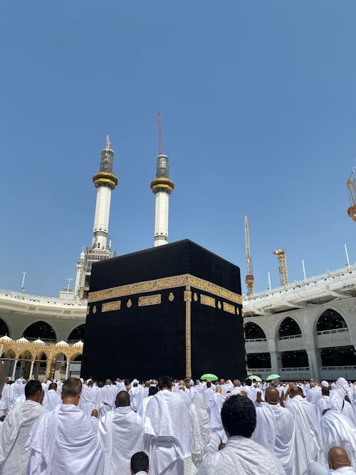 free photo of pilgrims praying in front of kaaba in the great mosque of mecca